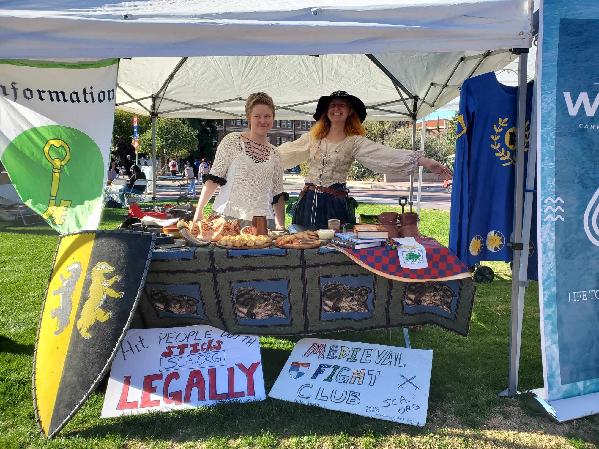 Young newcomers from the College of St. Felix welcoming folx to join the SCA at the UofA campus